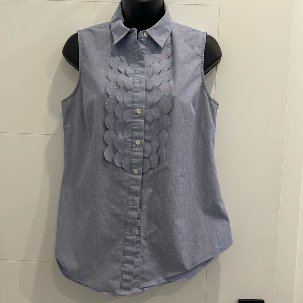 Blue sleeveless Riley shirt.